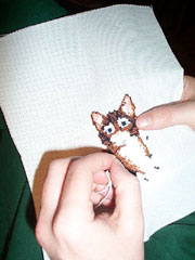 Cat in needlepoint; Actual size=180 pixels wide